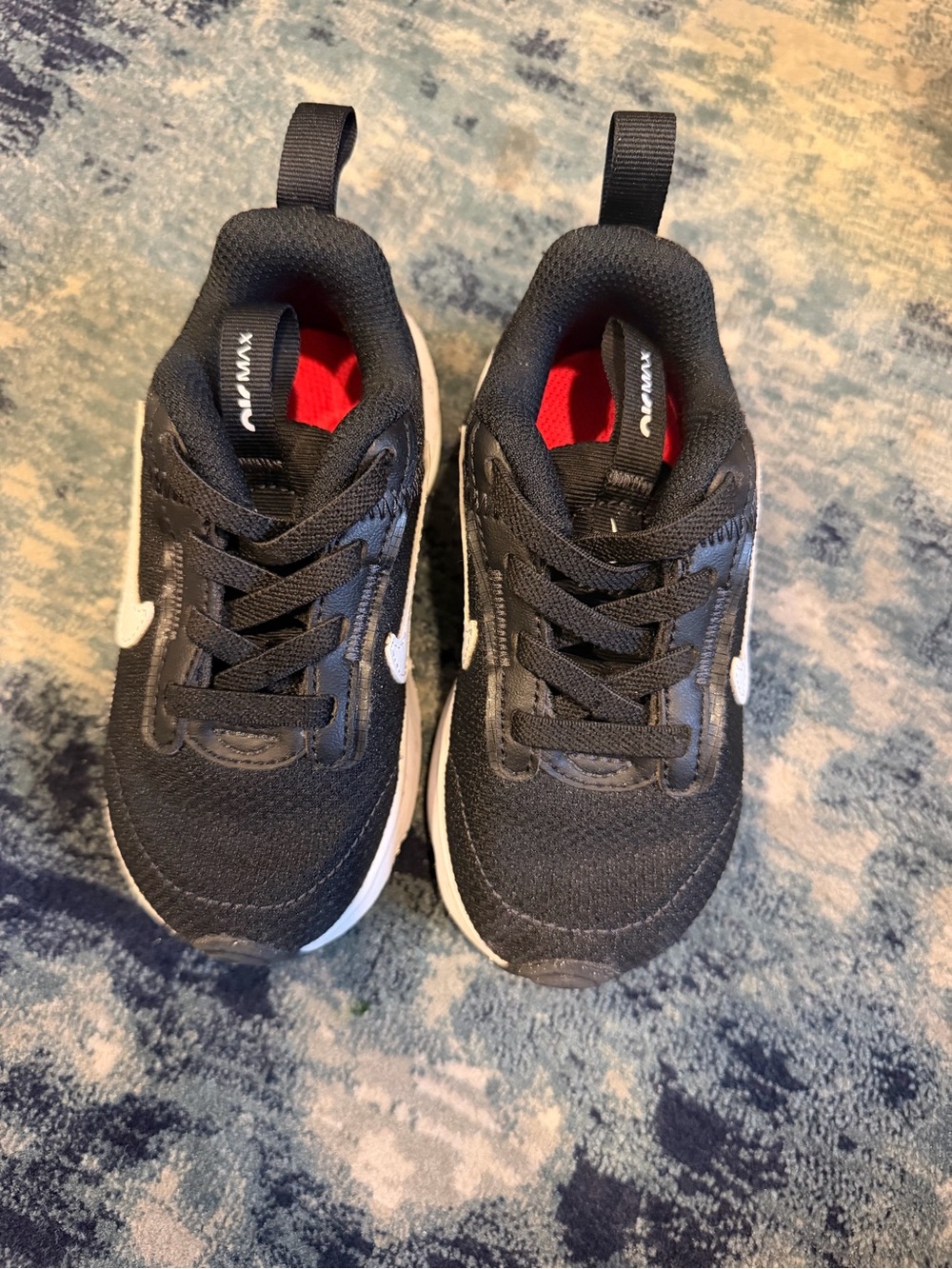 Nike Kids Black Sneakers with White Swoosh and Red Lining